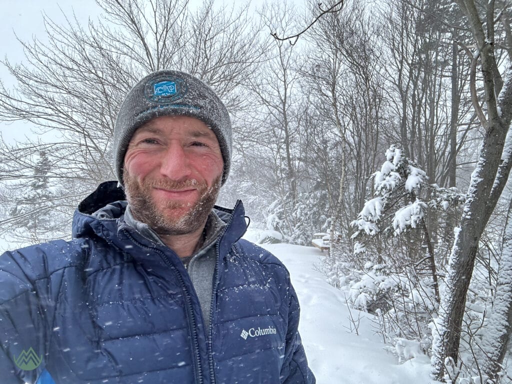 the author smiling in the snow